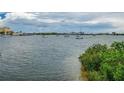 Peaceful waterfront view with boats and lush greenery along the shoreline at 4575 Cove Cir # 304, St Petersburg, FL 33708