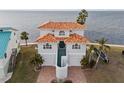 Two-story waterfront home with tile roof and attached garage at 6423 Driftwood Dr, Hudson, FL 34667
