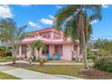 Pink two-story house with palm trees and stone patio at 700 S Prospect Ave, Clearwater, FL 33756