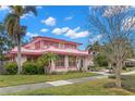 Pink house with landscaping and palm trees at 700 S Prospect Ave, Clearwater, FL 33756