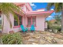 Small stone patio with two teal chairs at 700 S Prospect Ave, Clearwater, FL 33756