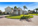 Large home with circular driveway and palm trees at 11518 Hammock Oaks Ct, Lithia, FL 33547