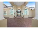 Elegant entryway with double doors and stonework at 11518 Hammock Oaks Ct, Lithia, FL 33547
