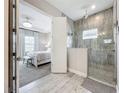 Modern bathroom with large walk-in shower and gray tile at 13028 Homestead Ln, Parrish, FL 34219