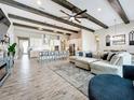Open floor plan living room and kitchen with high ceilings and exposed beams at 13028 Homestead Ln, Parrish, FL 34219