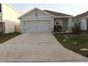 Charming single-story home featuring a well-manicured lawn and a spacious two-car garage at 1668 Hazy Sea Dr, Plant City, FL 33565