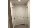 Bright hallway with three doors and tile floor at 1668 Hazy Sea Dr, Plant City, FL 33565