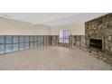 Unfinished basement with tiled floor and stone fireplace at 18838 Gulf Blvd # 202, Indian Shores, FL 33785
