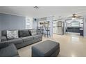 Open concept living room with adjacent kitchen and breakfast bar at 3421 Cantrell St, Holiday, FL 34690