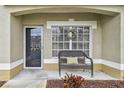 Inviting front porch with a bench, perfect for relaxing at 3607 Trafalgar Way # 103, Palm Harbor, FL 34685