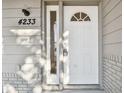 White front door with a transom window and keypad entry at 4233 Oakfield Ave, Holiday, FL 34691