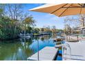 Relaxing waterfront dock with seating and umbrella at 5401 Circle Dr, Weeki Wachee, FL 34607