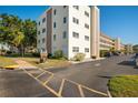 Exterior view of the condo building with parking at 5705 80Th St N # 304, St Petersburg, FL 33709