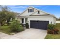 A charming house with a two-car garage, and a landscaped front yard at 5725 Stockport St, Riverview, FL 33578