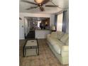 Living room features a beige couch and coffee table at 6216 N 44Th St, Tampa, FL 33610