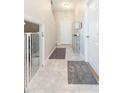 Bright and airy entryway with tile flooring, and access to a downstairs bedroom at 7236 Grand Elm Dr, Riverview, FL 33578
