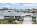 House exterior showcasing a gray facade, white garage door, and landscaping at 7800 3Rd S Ave, St Petersburg, FL 33707
