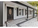 Inviting front entrance with a covered porch and stylish front door at 8334 139Th Ln, Seminole, FL 33776