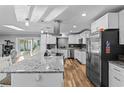 Modern kitchen featuring white shaker cabinets, granite countertops, and stainless steel appliances at 8334 139Th Ln, Seminole, FL 33776
