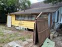 Back of house showing damaged fence and yard at 1209 E Dr Martin Luther King Jr Blvd, Tampa, FL 33603