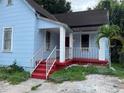 Front view of a light blue house with a red porch and white railings at 1209 E Dr Martin Luther King Jr Blvd, Tampa, FL 33603