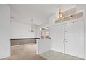 Bright entryway with white walls, tiled floors, and double doors at 1209 Peridot Ln, Sun City Center, FL 33573
