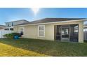 Backyard with screened patio and grassy area at 12410 Ballentrae Forest Dr, Riverview, FL 33579