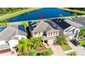 Two-story house with solar panels and a pond view in a residential area at 19510 Whispering Brook Dr, Tampa, FL 33647