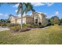 Exterior view of a charming house with landscaping at 2029 Inverness Greens Dr # 2029, Sun City Center, FL 33573