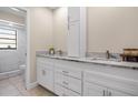 Updated bathroom with white cabinets, granite countertops, and marble shower at 2139 Abby Ave, Spring Hill, FL 34609