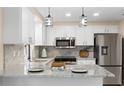Modern kitchen with white cabinets, granite counters, and stainless steel appliances at 2139 Abby Ave, Spring Hill, FL 34609