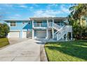 Two-story home with a two-car garage and a large deck at 2601 Bay Blvd, Indian Rocks Beach, FL 33785