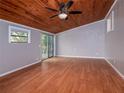 Bedroom with wood-look floors and access to a deck at 34027 Saint Joe Rd, Dade City, FL 33525