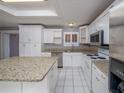 Bright kitchen with white cabinets and granite countertops at 34027 Saint Joe Rd, Dade City, FL 33525