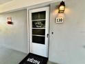 Inviting condo front door with a welcome mat and wreath at 8651 10Th N St # 130, St Petersburg, FL 33702
