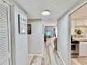 Bright hallway with light wood floors leading to living areas at 8651 10Th N St # 130, St Petersburg, FL 33702