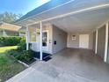 Carport with access to the front door of the house at 889 Sky Loch S Dr, Dunedin, FL 34698