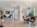 Dining area with glass table, four chairs and a chandelier at 10618 Foxcrest Way, Riverview, FL 33569