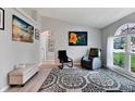 Living room features hardwood floors, large windows, and comfortable seating at 10618 Foxcrest Way, Riverview, FL 33569