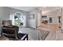 Bright living room with hardwood floors, comfortable seating and large windows at 10618 Foxcrest Way, Riverview, FL 33569