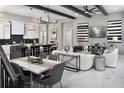 Open concept living space featuring a kitchen island, exposed beams and luxurious finishes throughout at 14638 Swiss Bridge Dr, Lithia, FL 33547