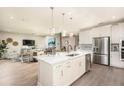 Open concept kitchen with large island and stainless steel appliances at 14814 Paddock Pond Ave, Lithia, FL 33547