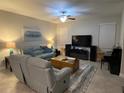 Spacious living room featuring comfortable seating, large TV, and piano at 17241 Old Tobacco Rd, Lutz, FL 33558