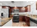 Bright condo kitchen with stainless steel appliances and granite countertops at 7 Elgin Pl # 208, Dunedin, FL 34698