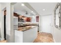 Spacious condo kitchen with granite countertops, stainless steel appliances, and dark wood cabinets at 7 Elgin Pl # 208, Dunedin, FL 34698