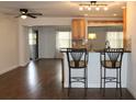 Eat-in kitchen with light wood cabinets, granite countertops, and breakfast bar at 9705 45Th N Way, Pinellas Park, FL 33782