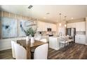 Kitchen dining area with wood table and white chairs at 10237 Fieldstone Myrtle Way, San Antonio, FL 33576