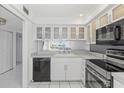 Modern white kitchen with stainless steel appliances at 105 Island Way # 146, Clearwater, FL 33767