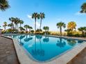 Relaxing community pool with palm trees and lounge chairs at 1270 Gulf Blvd # 1206, Clearwater Beach, FL 33767