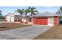 House with detached workshop and red garage door at 13101 Delbarton St, Spring Hill, FL 34609
